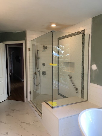 How do glass shower doors change the look and function of a bathroom